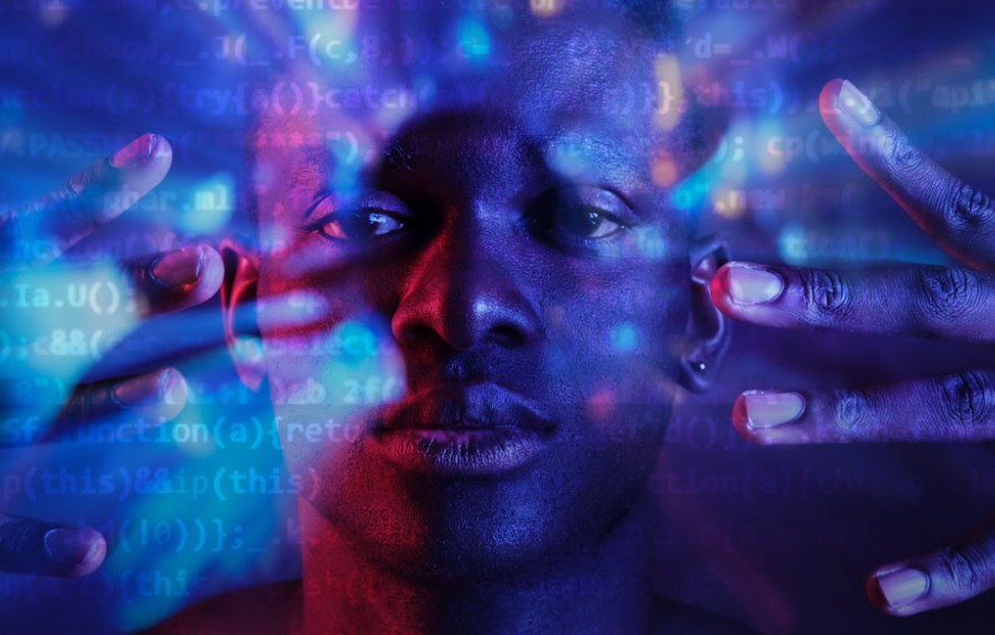 Man with hands near face he codes by hand.